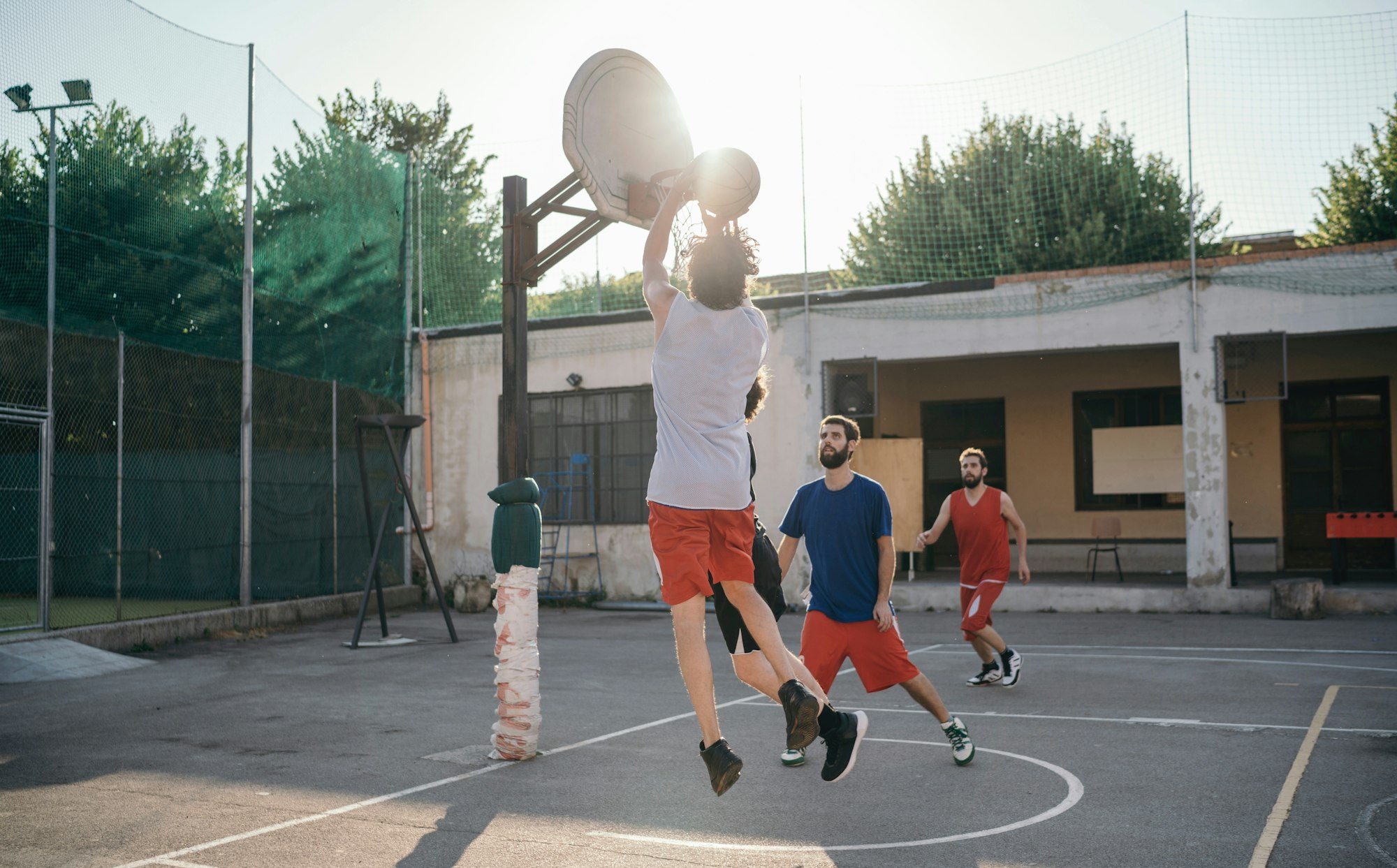 Friends on basketball court playing basketball game